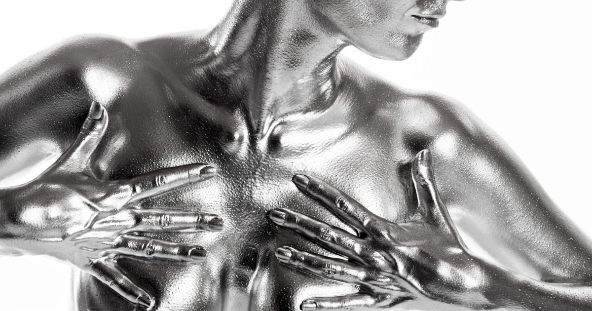 a woman's chest with her body and hands painted with silver colour :: photo copyright Karin Bergmann