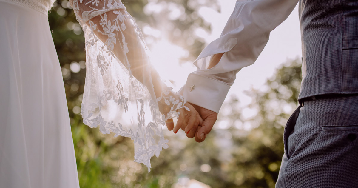 Wedding photo by wedding photographer, bridal couple holding hands, close-up :: photo copyright Karin Bergmann